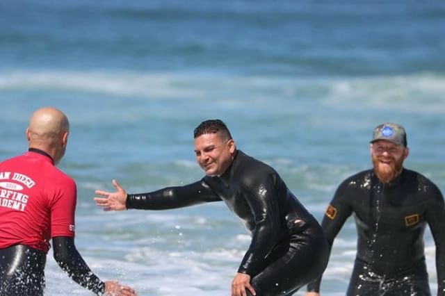 Alegria estampada em aula de surfe para turma de cegos em Ponto Beach, Califórnia.
